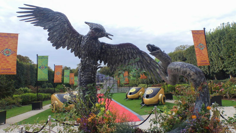 Panem-inspired Mockingjay and serpent sculptures at The Hunger Games Elegance Is Authority installation in Paris.