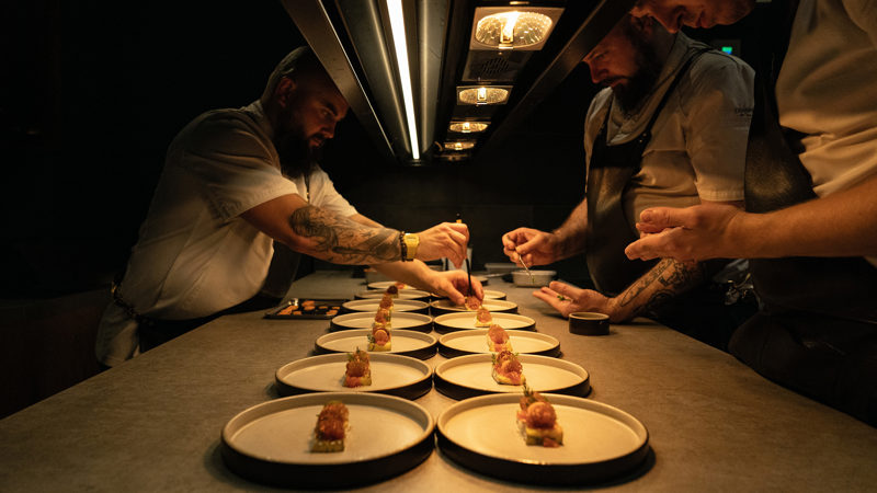 Chefs carefully plate dishes in the Vraic kitchen in Knife Edge: Chasing Michelin Stars Season 2.