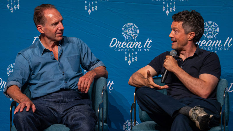Ralph Fiennes and Christian Coulson speak together during Enter The Magical World 4 in Courbevoie, France.